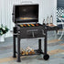 large outdoor BBQ grill in use on patio – charcoal grill with food cooking for garden event