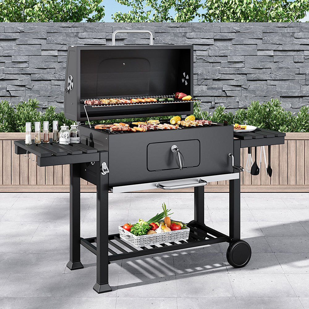 Outdoor charcoal BBQ grill in garden setting – 33x43 inch barrel barbecue with side shelves, perfect for backyard parties