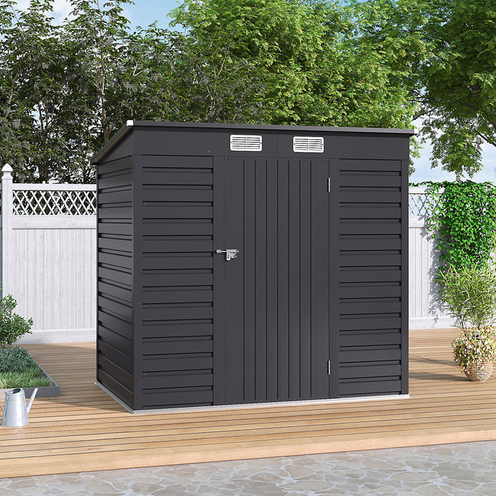 Closed 6x4ft galvanized steel garden shed placed on patio floor against wooden fence – ideal for garden tools and equipment