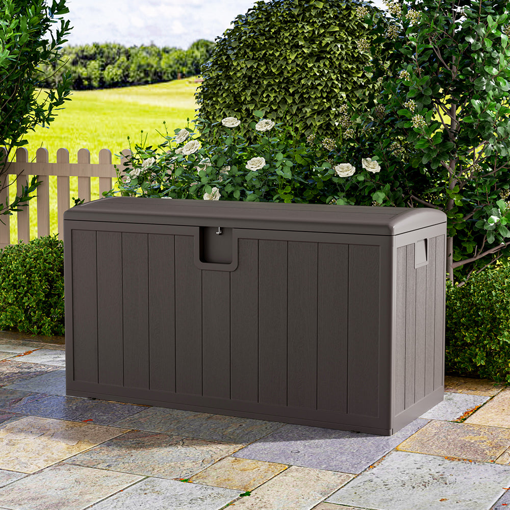 Brown rattan deck box in outdoor space – 127x61x63.5cm lockable garden storage box