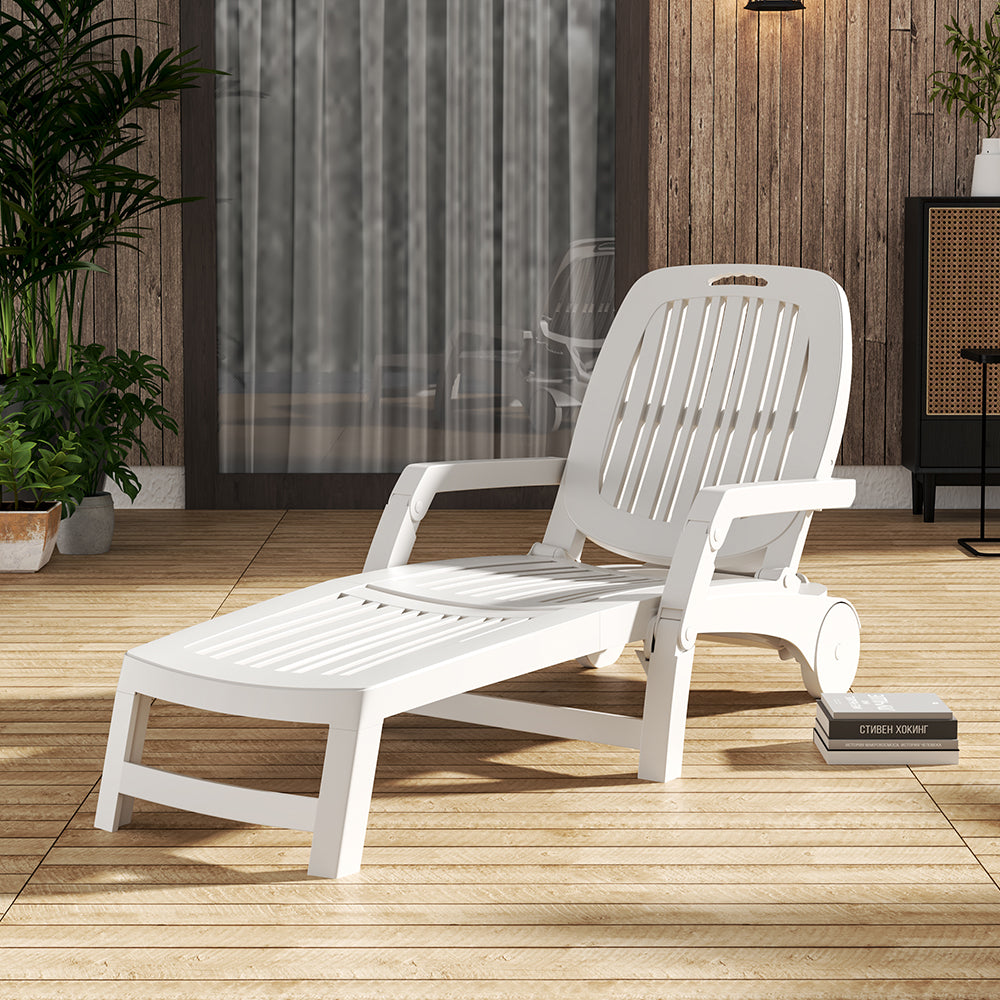 White wheeled folding recliner next to barbecue setup in outdoor party scene