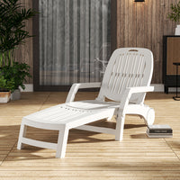 White wheeled folding recliner next to barbecue setup in outdoor party scene
