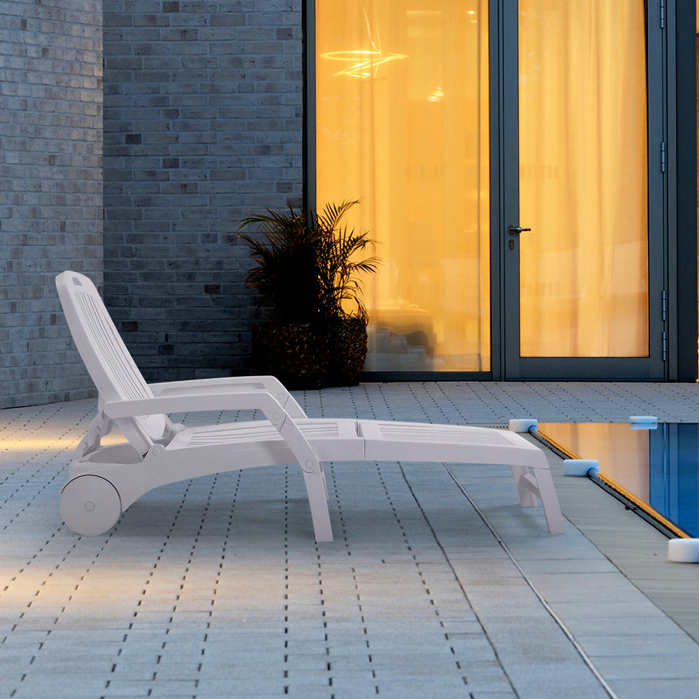 Woman relaxing on white lounge chair in backyard garden setting