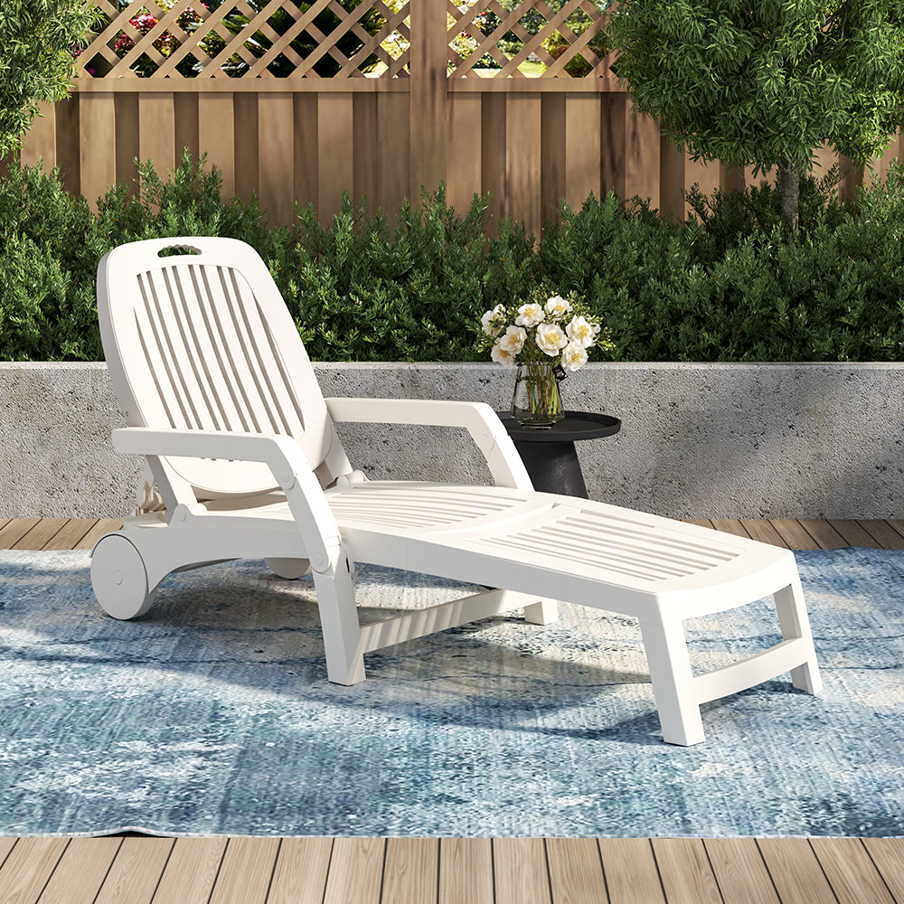 White outdoor folding lounge chair by the poolside – garden furniture setup