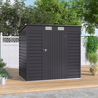 Closed 6x4ft galvanized steel garden shed placed on patio floor against wooden fence – ideal for garden tools and equipment