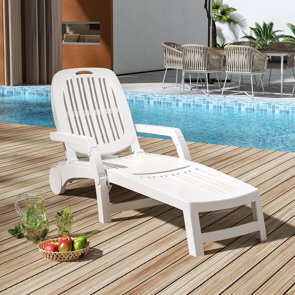 White garden recliner chair on grass under parasol – summer lounging
